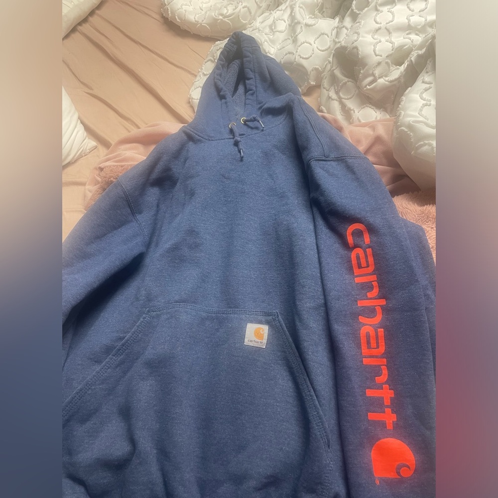 Carhartt hoodie, navy blue with bright orange lettering along the sleeve.